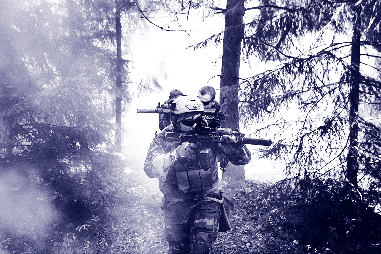 A military member in a cloudy jungle.